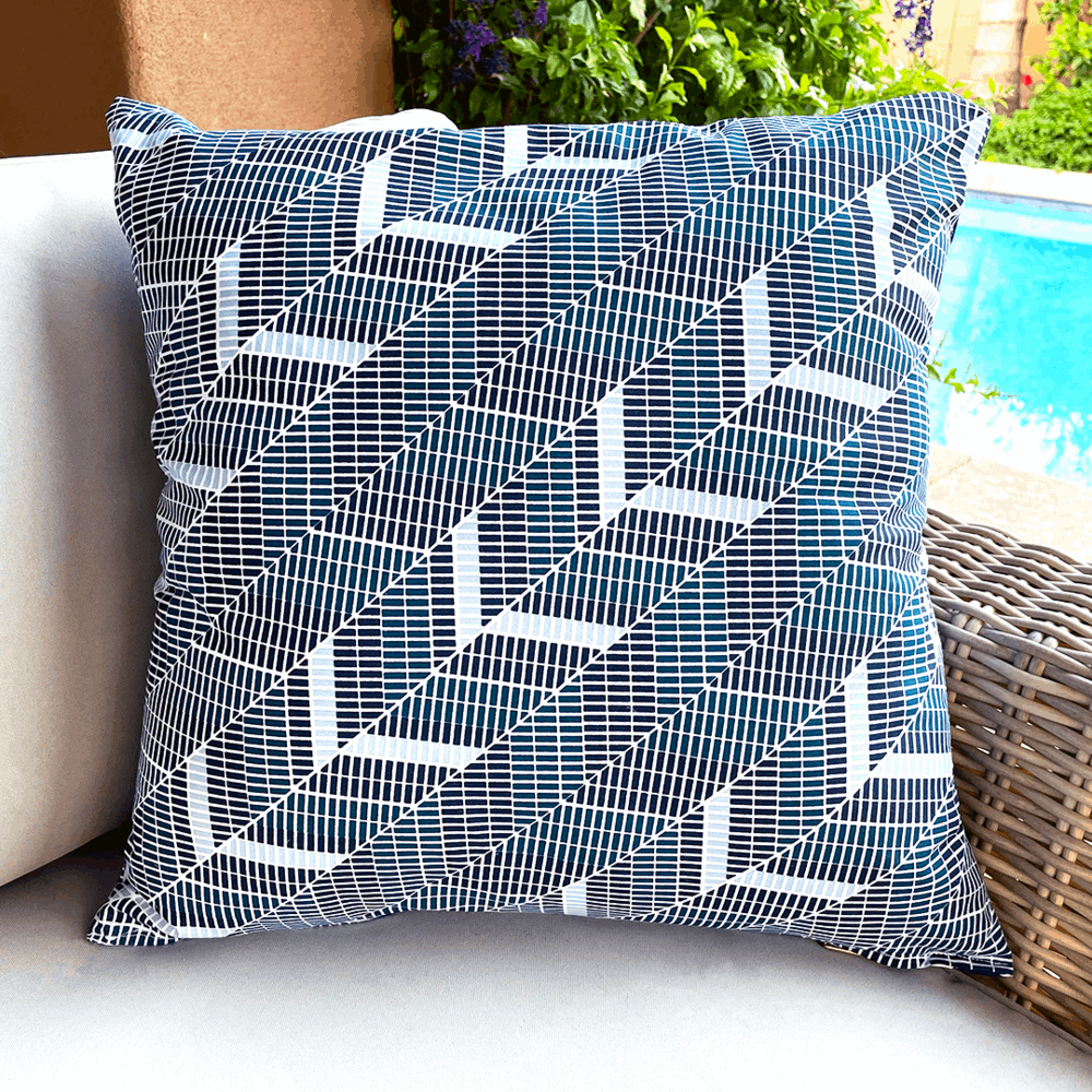 navy teal and white geometric diagonal herringbone pillow on outdoor couch