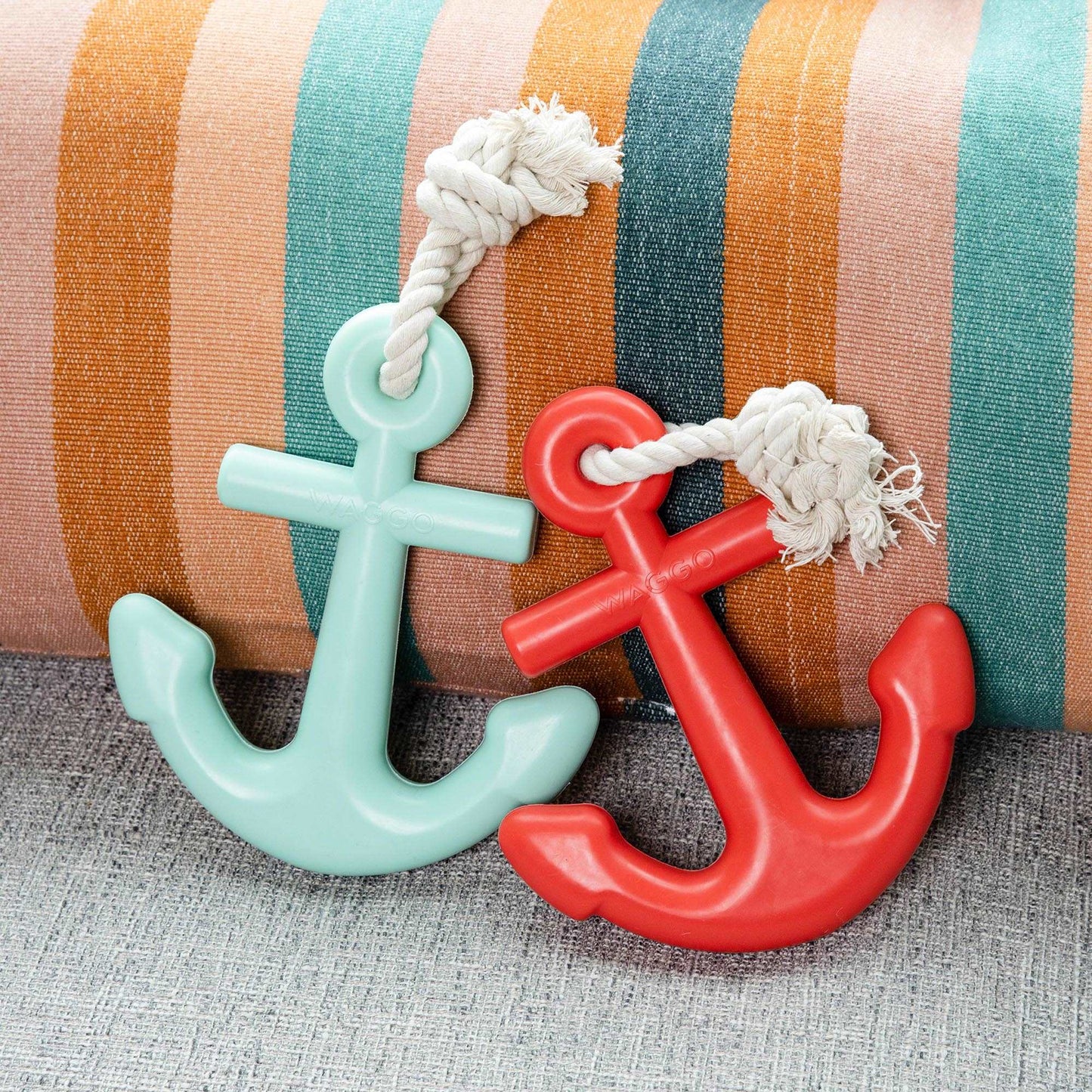 sea green and red anchor dog chew toy on pillow