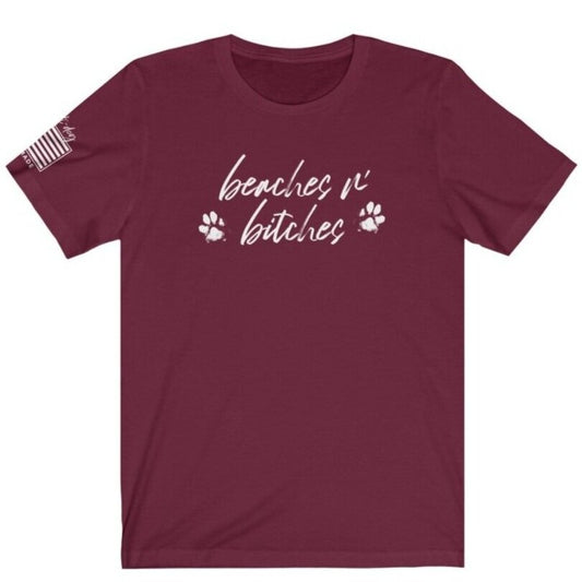 maroon t-shirt with beaches n' b*tches script and flag emblem on sleeve